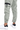 Light green joggers with elastic cuffs and a zippered pocket, paired with white sneakers featuring a black heel.