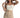 Model wearing the white Emmie Strapless Bustier Top with a structured bodice and tan pleated trousers.