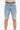 Light blue denim shorts with a distressed finish and rolled hems, featuring a black waistband.