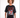 Model wearing a black oversized Feel and Heel graphic tee with a heart and flames streetwear design.