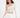 Model wearing the Lexie nude one-shoulder ribbed crop top with long sleeve and white joggers.