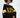 ALPES Black Ribbed Crop Top with yellow stripes and Snow Region graphic. Modern streetwear aesthetic for women.