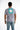 Back view of a man in a lilac Make It Happen graphic streetwear tee featuring urban typography and a teal square design.