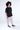 Men's Harvey cargo pants in stone with baggy fit and side utility pockets paired with black streetwear t-shirt.