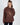 Model wearing a brown NY graphic sweatshirt with ribbed crew neck and oversized streetwear fit.