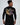 A person wearing a black long-sleeve shirt featuring colorful abstract text and graphic designs on the back.