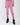 Pink cropped joggers with elastic cuffs, paired with black platform ankle boots on a model.