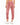 Pink velvet joggers with an elastic waistband and cuffed ankles, paired with white sneakers.