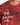Red graphic t-shirt featuring intricate patterns and a motivational quote in white cursive text.