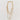 Golden Glow Minimalist layered necklace featuring a gold curb chain, starfish charm, and gemstone on a white background.