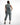 Back view of Faye Denim Jumpsuit in blue wash utility style featuring an elastic waist, cargo pockets, and tapered legs.