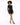 A model poses in a fitted black sequined dress with long sleeves, paired with black high-heeled shoes.