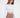 Model wears the Adriana off-shoulder long sleeve crop top in white with a unique strap neckline and brown trousers.