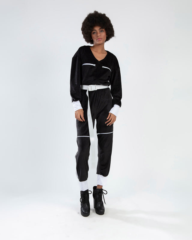 Finaley Black Romper with white belt and zipper details worn by a model in a streetwear style.
