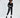 Finaley Black Romper with white belt, zipper accents, and contrast cuffs worn by a model in black platform boots.