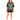 A woman stands wearing a loose-fitting gray t-shirt with a colorful New York graphic, paired with black shorts and sn...