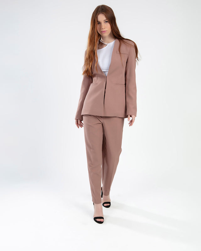 Model in Carbon Fiona Two-Piece Jacket Set in Wild Mushroom mauve with matching blazer and trousers.