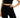 A model poses in a fitted black crop top and matching high-waisted shorts, showcasing a sleek, minimalist style.