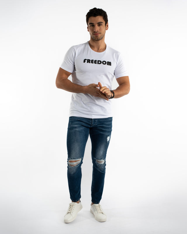 Men's Carbon Nixon blue distressed jeans with ripped knees and tapered leg in a streetwear style.