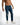 Front view of Nixon blue distressed jeans for men featuring ripped knees and a streetwear fade.
