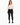 A model wearing a fitted long-sleeve bodysuit with a deep V-neck and cut-out sides, paired with black skinny jeans.