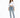 A woman stands confidently in a cropped white long-sleeve shirt and light blue jeans, paired with gray slippers.