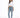 A woman stands confidently in a cropped white long-sleeve top, light blue jeans, and gray fuzzy slippers.