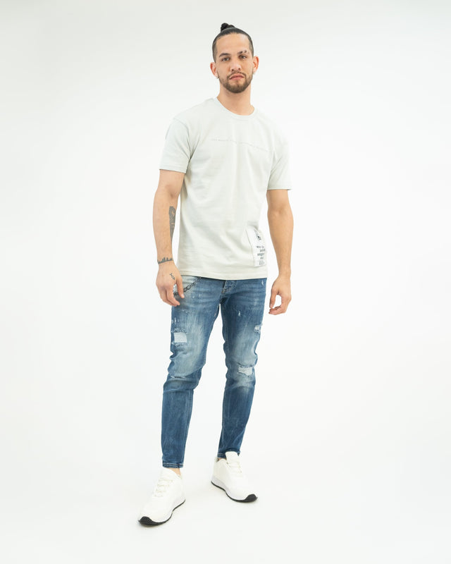 Men's Andy Blue Washed Jeans with distressed denim detail and pocket chain, style on white background.