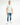 Men's Andy blue washed jeans featuring distressing and a metal pocket chain, styled with a grey tee and white sneakers.