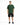 A man stands wearing a green oversized t-shirt with white text, paired with black cargo shorts and sneakers.