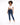 A model with curly hair wears a white cropped top and dark blue skinny jeans, paired with white sneakers.