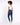 A model with curly hair wears a white fitted top and blue skinny jeans, paired with white sneakers.