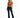 A woman stands confidently in a cropped, rust-colored top and dark flared jeans, paired with black heels.