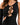 A close-up of a black apparel item featuring a crisscross design and cut-out details, highlighting its unique style.