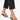 Ankle with a colorful beaded chain, paired with black flip-flops and cropped black pants.