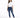 A woman stands confidently in a casual white t-shirt and fitted blue jeans with distressed details.