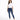 A woman stands confidently in a casual white t-shirt and fitted blue jeans with distressed details.