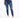 A person wearing fitted blue jeans with distressed knee details and white sneakers, standing against a plain background.