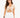 A model wearing a beige cropped top with a V-neck and drawstring detail, paired with white denim shorts.