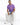 A man sits on a white cube wearing light blue distressed jeans, a purple graphic t-shirt, and white sneakers.