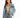 A woman poses in a light blue denim jacket over a fitted green top, paired with high-waisted blue jeans.