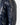 Shiny navy coat featuring a zippered pocket on the sleeve and a sleek, modern design.