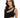 A model showcases a sleek black dress with a unique cutout design and asymmetrical neckline.