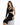 A model poses in a fitted black dress featuring an asymmetrical design and cut-out details, complemented by a chain n...