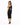 A woman poses in a fitted black dress with a one-shoulder design and cut-out details, paired with black heels.