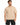 A man wearing a beige oversized t-shirt paired with black denim shorts, standing against a white background.