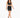 A model walks confidently in a black cropped top and matching skirt with lace-up details and a bow tie.