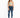 A model wearing a fitted, light green crop top paired with distressed blue skinny jeans and white sneakers.
