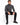 A man sits on a white cube, wearing a gray turtleneck sweater and black pants, paired with black sneakers.