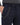 Close-up of navy pants featuring a side pocket with a silver chain attached for added style and functionality.